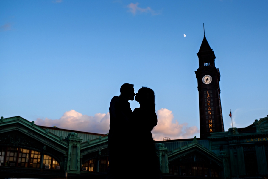 A silhouette of an engaged couple in hoboken, NJ at the train station.